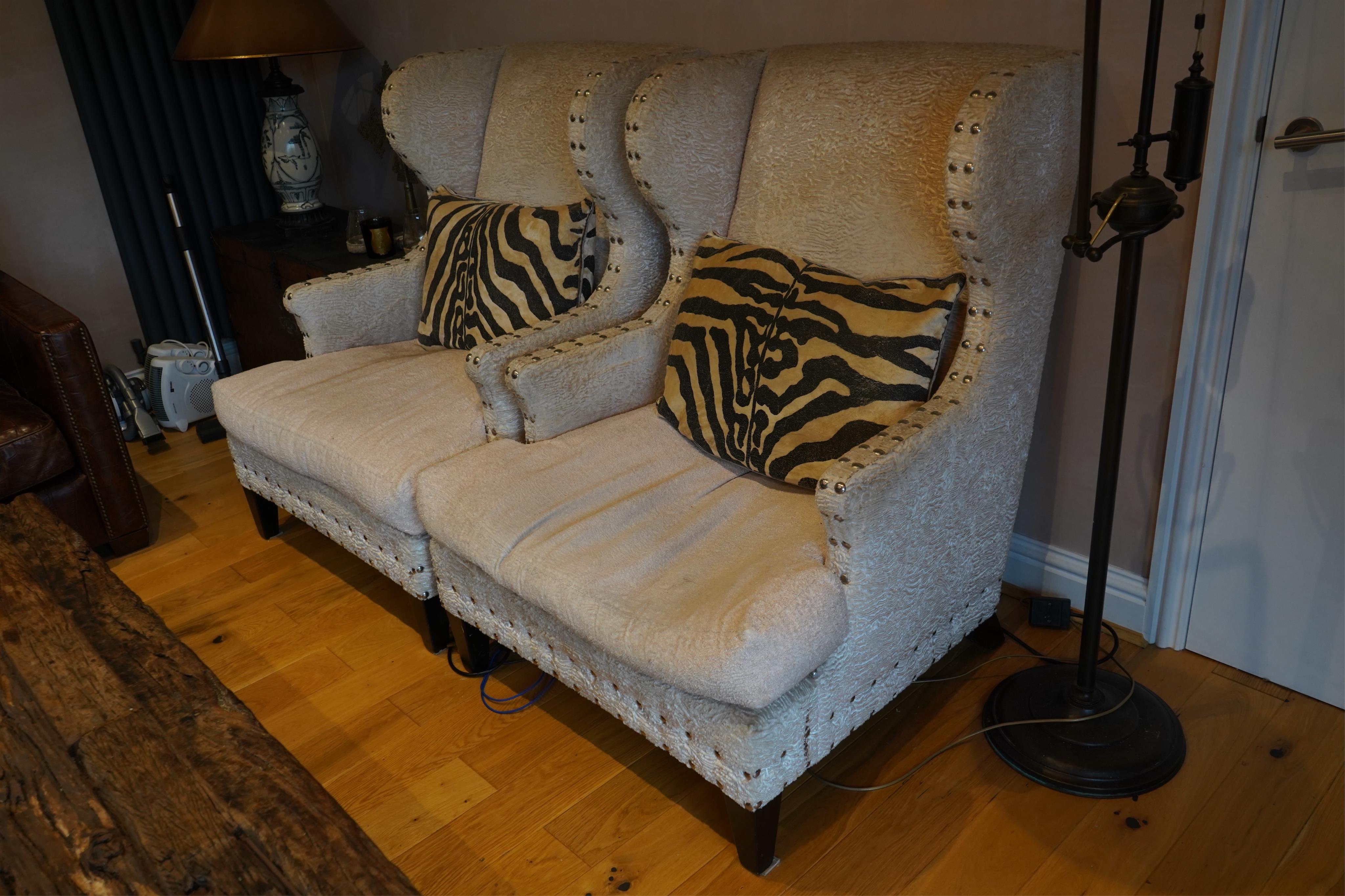 A pair of Martin Fleming armchairs with zebra cushions, width 85cm, depth 80cm, height 112cm. Condition - fair